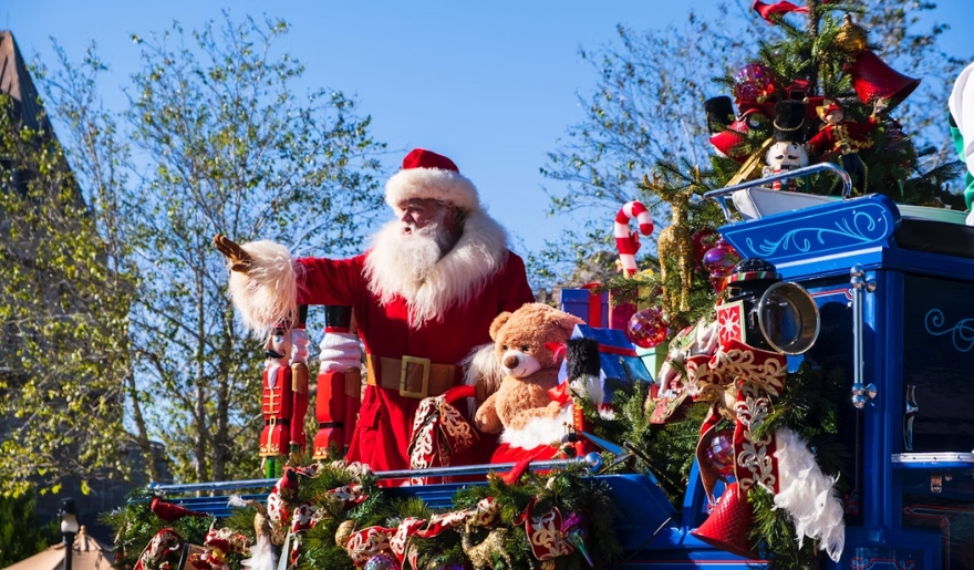 Santa Claus smiles and waves from a parade float at the Myrtle Beach Christmas event in Surfside Beach.