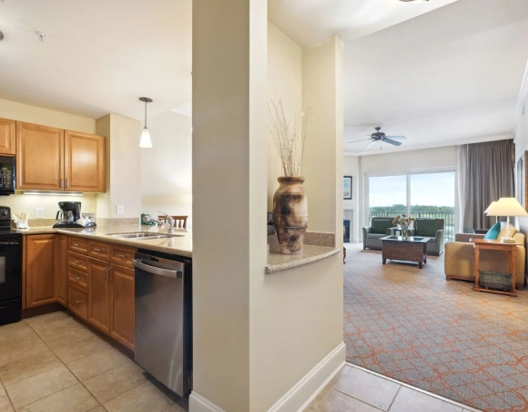 A suite kitchen opening into a furnished living room