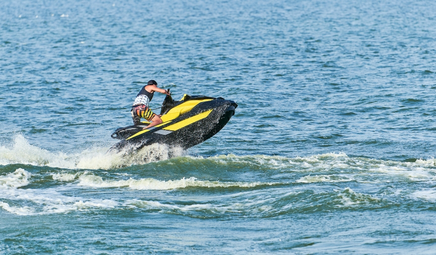 A man riding a jet ski across the ocean waves, showcasing water sports at Myrtle Beach.