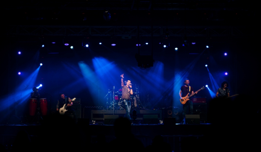 A lively band on stage with blue lighting, highlighting the energetic atmosphere of Myrtle Beach's live entertainment scene.