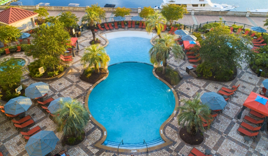 A pool surrounded by lounge chairs and umbrellas, ideal for relaxation during a Myrtle Beach vacation.