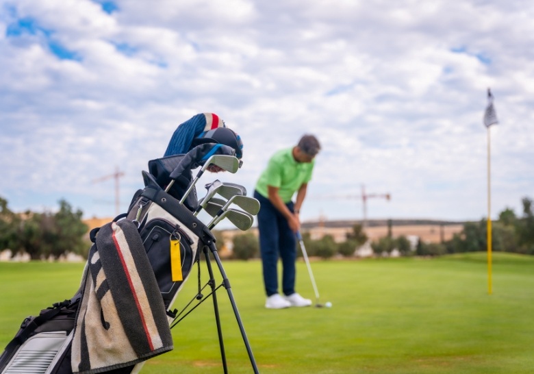 Golfer putting on course near Marina Inn at Grande Dunes Myrtle Beach