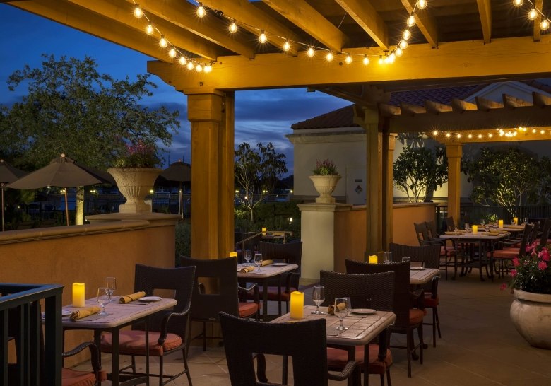 Outdoor dining at WaterScapes restaurant in Myrtle Beach with warm lighting and elegant ambiance