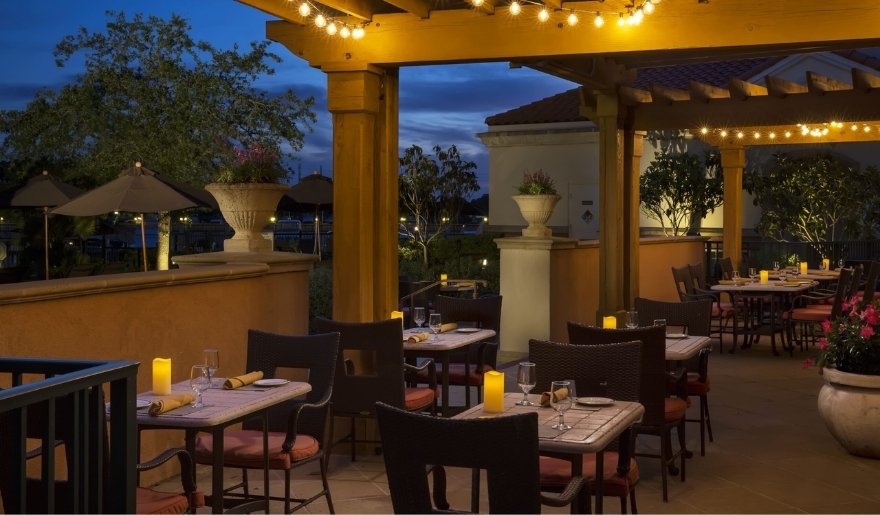 Outdoor dining with string lights and cozy seating at Waterscapes Restaurant at Marina Inn