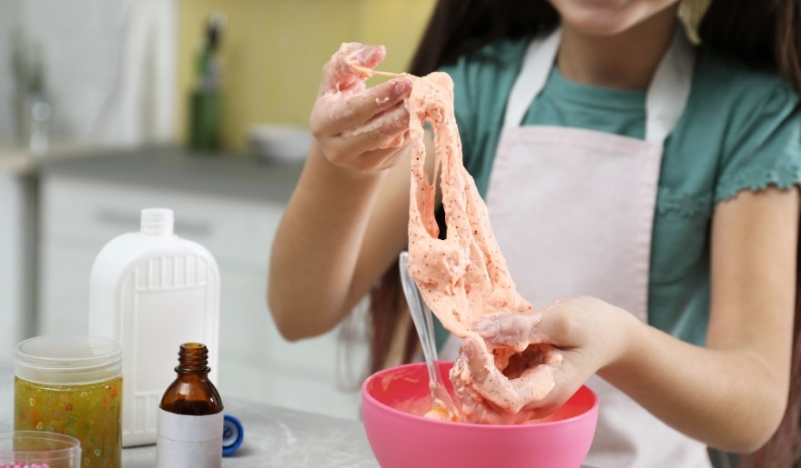 Child making colorful slime at Slime Kitchen, a fun hands-on activity for kids in Myrtle Beach