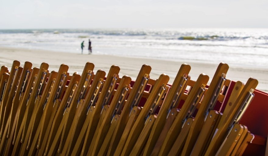 Private beach access with lounge chairs on Myrtle Beach shore with calm weather during Myrtle Beach in July