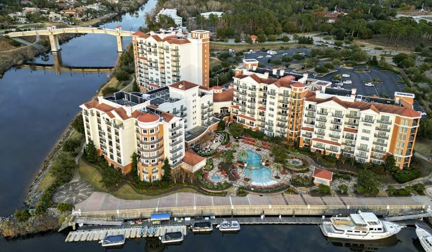 Aerial view of Marina Inn at Grande Dunes showing the waterfront marina, resort pools, guest suites, and surrounding Intracoastal Waterway, emphasizing the resort’s scenic location and amenities in Myrtle Beach.