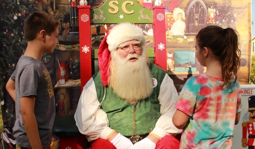 Santa Claus greets visitors at the fairgrounds for holiday photos during the Myrtle Beach Christmas celebration at Tanger Outlets.