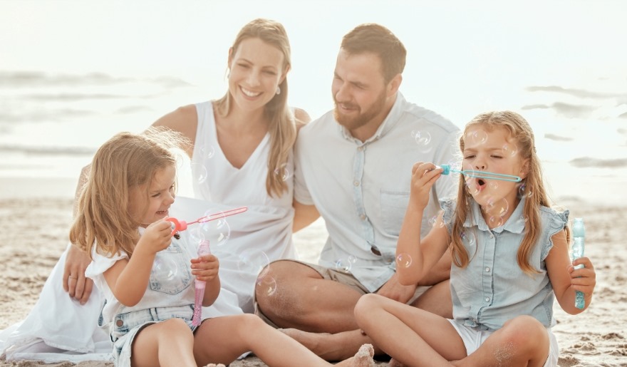A family enjoying a beach day at Myrtle Beach, creating memories with their children during a vacation.