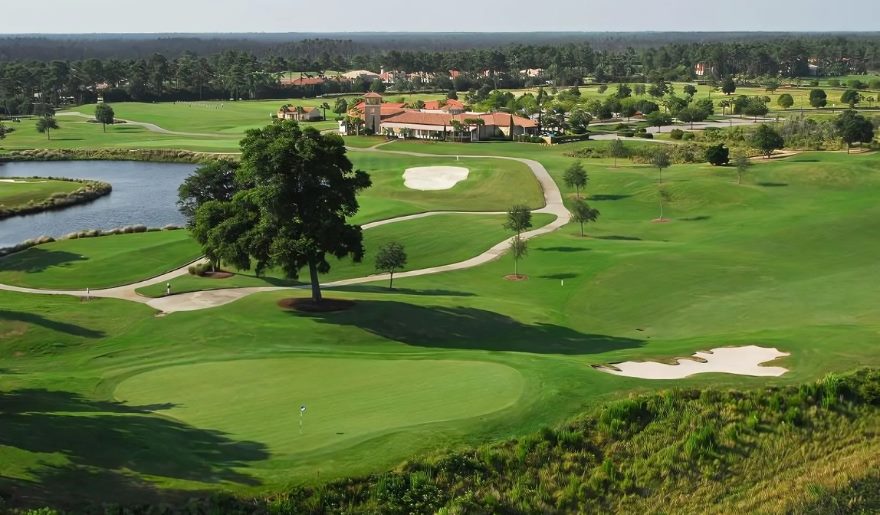 Scenic golf course featuring a tranquil pond and expansive lake, ideal for Myrtle Beach golf trips.