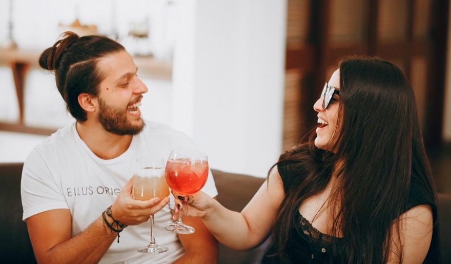 A couple raises their glasses in a toast at Duplin Winery, enjoying a romantic moment in Myrtle Beach.
