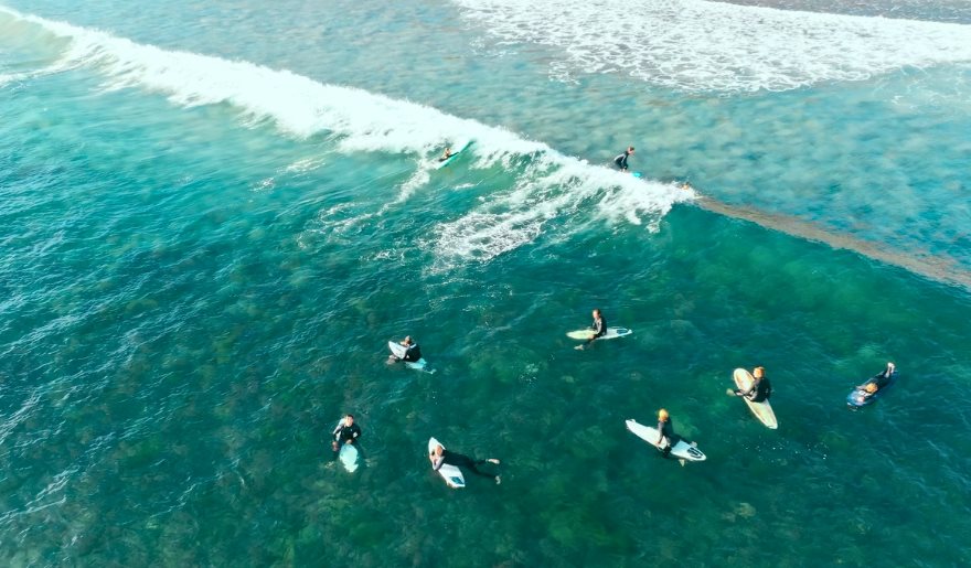 Surfers enjoying the waves at Myrtle Beach, part of family-friendly activities at Kokopelli Surf Camp.