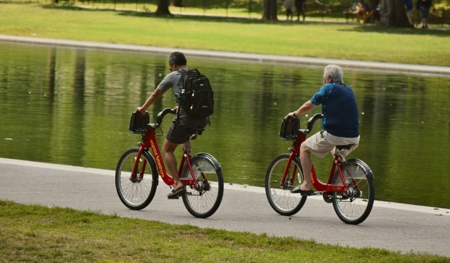 Cyclists riding beside a pond while exploring Myrtle Beach outdoors in October