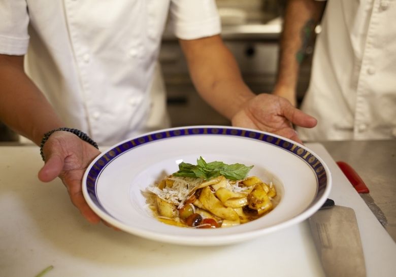 Chef preparing fresh cuisine at Marina Inn Myrtle Beach restaurant
