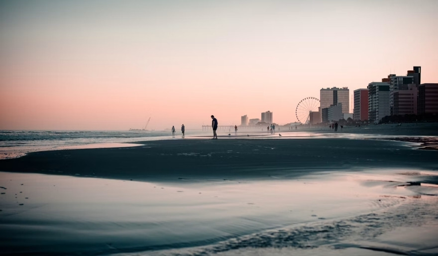 Myrtle Beach shoreline at sunset during winter with the SkyWheel in the distance.