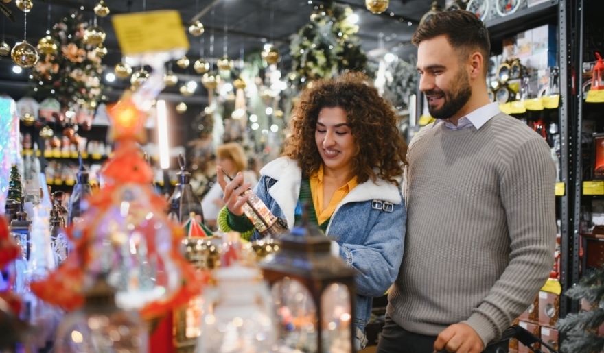 Couple browsing holiday gifts and seasonal decorations while winter shopping in Myrtle Beach.