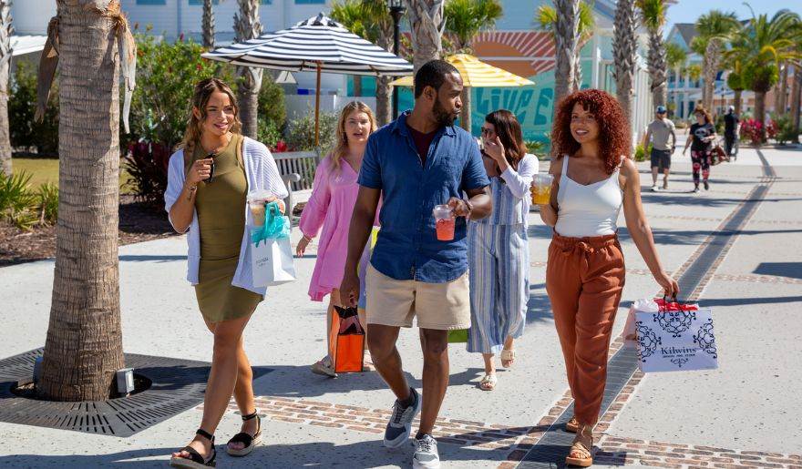 Black Friday shoppers carrying bags while exploring Myrtle Beach holiday shopping destinations.
