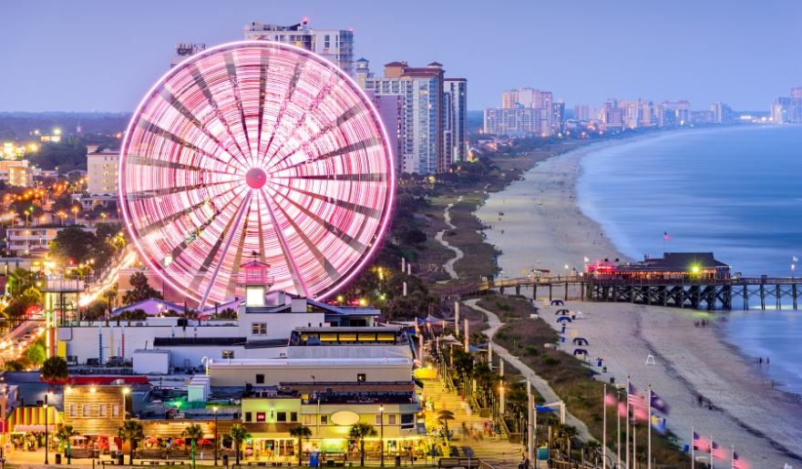 Myrtle Beach winter scene with the SkyWheel, illuminated boardwalk, and oceanfront skyline.
