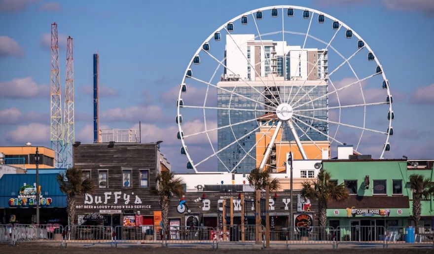 Myrtle Beach Boardwalk in December featuring the SkyWheel, beachfront shops, and local restaurants.