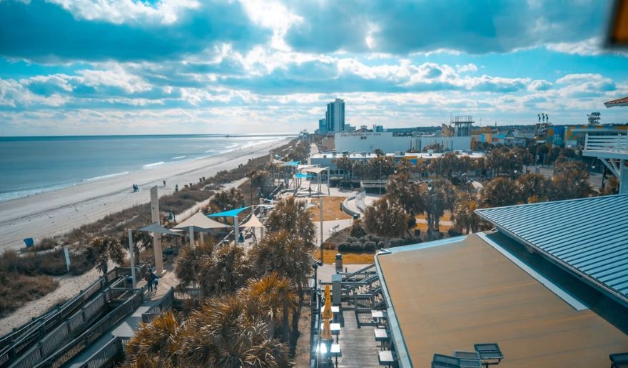 Myrtle Beach in December with a sunny coastline, sandy beach, and oceanfront boardwalk.