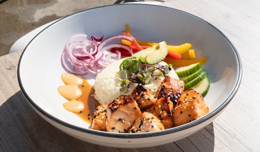 Grilled salmon bowl with rice and fresh vegetables at 357 Raw in Myrtle Beach.